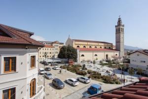a view of a city with cars parked in a parking lot at Bellway Guest House in Shkodër