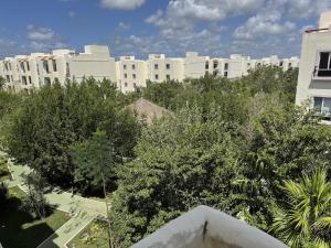 a view of a city with tall buildings and trees at Comfortable 2BR Condo pool & gym in Tulum