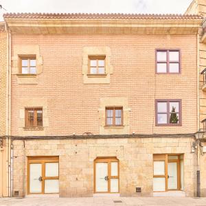 a large brick building with many windows at Rosario 32 by keyhom in Salamanca