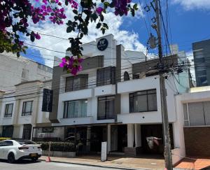 a building with a clock on top of it at Hotel Versalles Boutique in Pasto