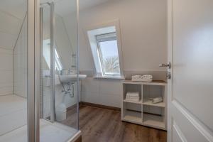 a bathroom with a shower and a sink at Ankerplatz Sylt in Sylt +54 photos