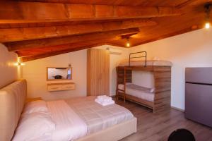a bedroom with a bed and a bunk bed at Bellway Guest House in Shkodër