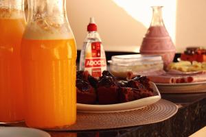 a plate of food and a bottle of orange juice at Pousada - Árvore da Vida in Bonito +22 photos