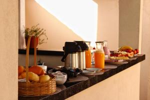 a buffet of food and fruit on a counter at Pousada - Árvore da Vida in Bonito