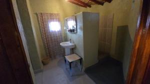 a small bathroom with a sink and a mirror at ecolodge bivouac des aigles in Ouarzazate