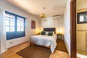 a bedroom with a bed and a large window at Luxury House Sofie in Tías