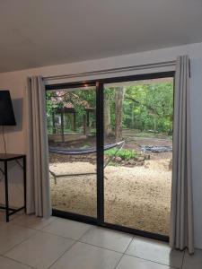 a sliding glass door with a view of a yard at The Paradise Jungle Studio in Coco