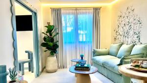 a living room with a blue couch and a table at Aldea Calma in Sanxenxo
