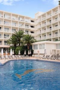 a swimming pool in front of a hotel at BLUESEA Coral Beach in Es Cana