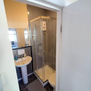 a bathroom with a shower and a sink at South Cliff Hotel in Blackpool