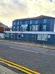 a blue building on the side of a street at South Cliff Hotel in Blackpool