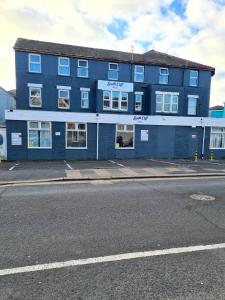 a blue building on the side of a street at South Cliff Hotel in Blackpool