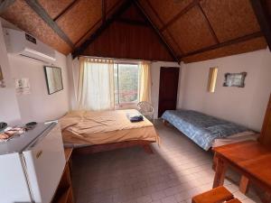 a bedroom with two beds and a sink in a room at Hotel Witttmer in Puerto Velasco Ibarra