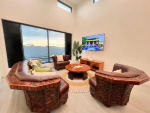 a living room with two couches and a tv at Solana Properties in Nadi
