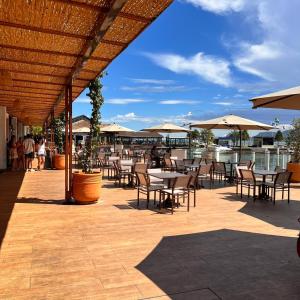 an outdoor patio with tables and chairs and umbrellas at Angra Sea House in Angra dos Reis