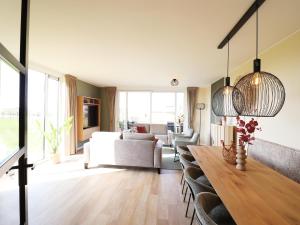 a living room with a table and a couch at Luxury waterfront villa in Leons