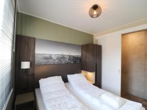 a bedroom with a large bed with white sheets at Luxury waterfront villa in Leons