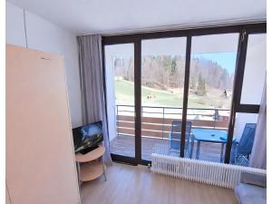 a living room with a large window with a view at Studio Bernhard mit Pool und Sauna in Freyung