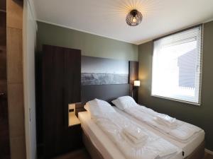 a bedroom with two beds in it with a window at Luxury waterfront villa in Leons