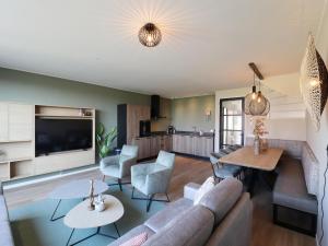 a living room with a couch and a table at Luxury waterfront villa in Leons