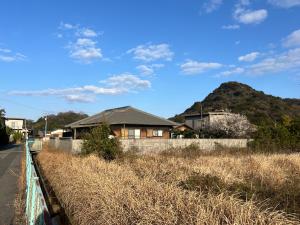 a house on the side of a road with a hill at Bunkyo in Naoshima