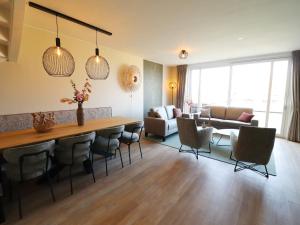 a living room with a table and chairs at Luxury waterfront villa in Leons