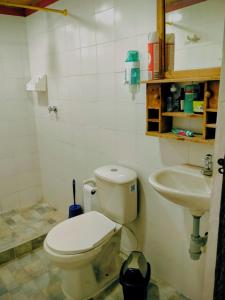 a bathroom with a toilet and a sink at Finca la Riverita in Sutamarchán +23 photos