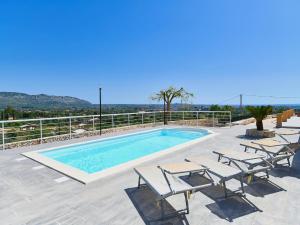 a swimming pool with chaise lounge chairs and a swimming pool at Villa with private pool in Floridia in Floridia
