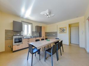 a kitchen and dining room with a table and chairs at Villa with private pool in Floridia in Floridia