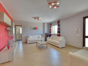 a living room with two white couches and a table at Villa with private pool in Floridia in Floridia
