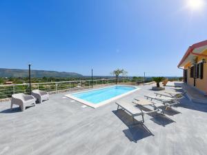 a swimming pool with chaise lounge chairs and a swimming pool at Villa with private pool in Floridia in Floridia