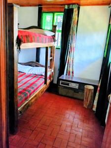 a room with two bunk beds in a house at Finca la Riverita in Sutamarchán