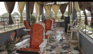 a row of chairs sitting on a balcony at Bomi Bar in King Faro