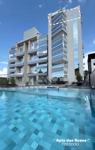 a swimming pool in front of a building at Apto Rosas| 3Q, todo Climatizado, Prox das Termas in Piratuba