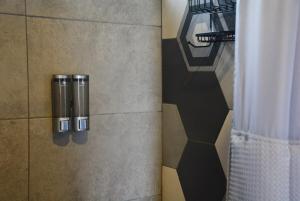 a bathroom with a shower curtain next to a window at Private Mountain Cabin with Garden Views in Zarcero +35 photos