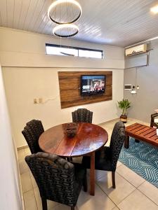 a dining room with a wooden table and chairs at CDE House in Ciudad del Este