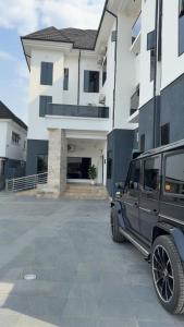 a black jeep parked in front of a building at Rex&Rich Hotel and Suites in Umu Oma