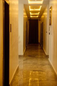 a hallway of an office building with a long corridor at Rex&Rich Hotel and Suites in Umu Oma