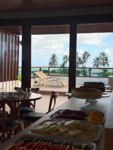 a buffet with a view of the ocean from a resort at Hotel Kanto Do Chico Conceito in Icaraí