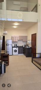 a large room with a kitchen with a stove at Luxury Azha Ain Sokhna Villa - Pool & Garden Views in Ain Sokhna