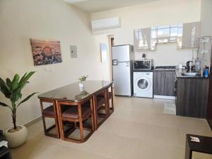 a kitchen with a table and a refrigerator at Luxury Azha Ain Sokhna Villa - Pool & Garden Views in Ain Sokhna