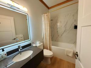 a bathroom with a sink and a toilet and a shower at Bear's Claw Lodge in Cache Creek +43 photos