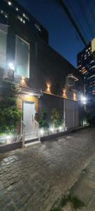 a building with a door on the side of it at night at Lofts portal 225 unid 01 in Recife