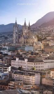 a view of a city with buildings and a clock tower at Hostal home 3 in Quito