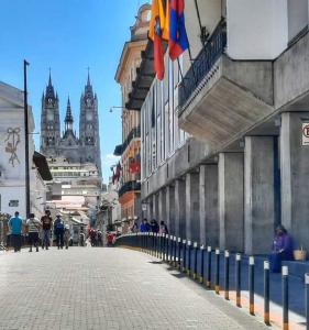 a street with flags and people walking on the street at Hostal home 3 in Quito +16 photos