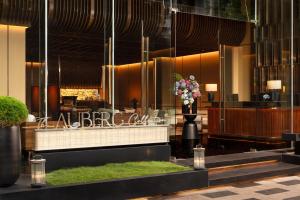 a lobby of a hotel with a vase of flowers at The Auberg Collection Hotel in Ho Chi Minh City +13 photos