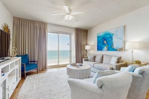 a living room with a couch and a table at TOPS'L Tides 704 in Destin
