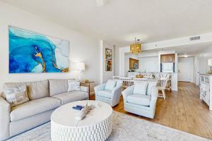 a living room with a couch and a table at TOPS'L Tides 704 in Destin