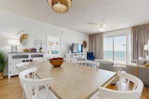 a dining room and living room with a table and chairs at TOPS'L Tides 704 in Destin +25 photos