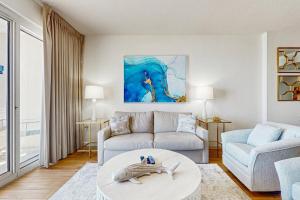 a living room with a couch and a table at TOPS'L Tides 704 in Destin